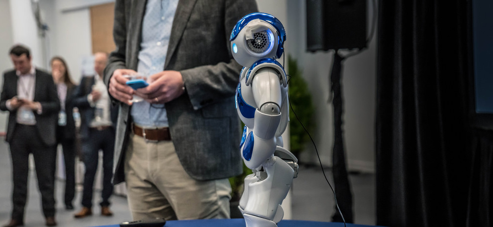 man showcasing small robot