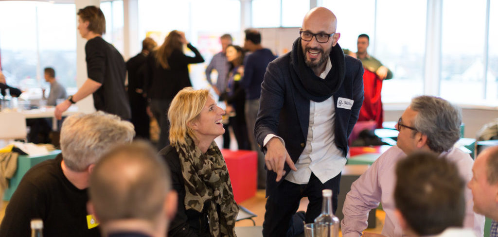 People talking around a table at a networking event