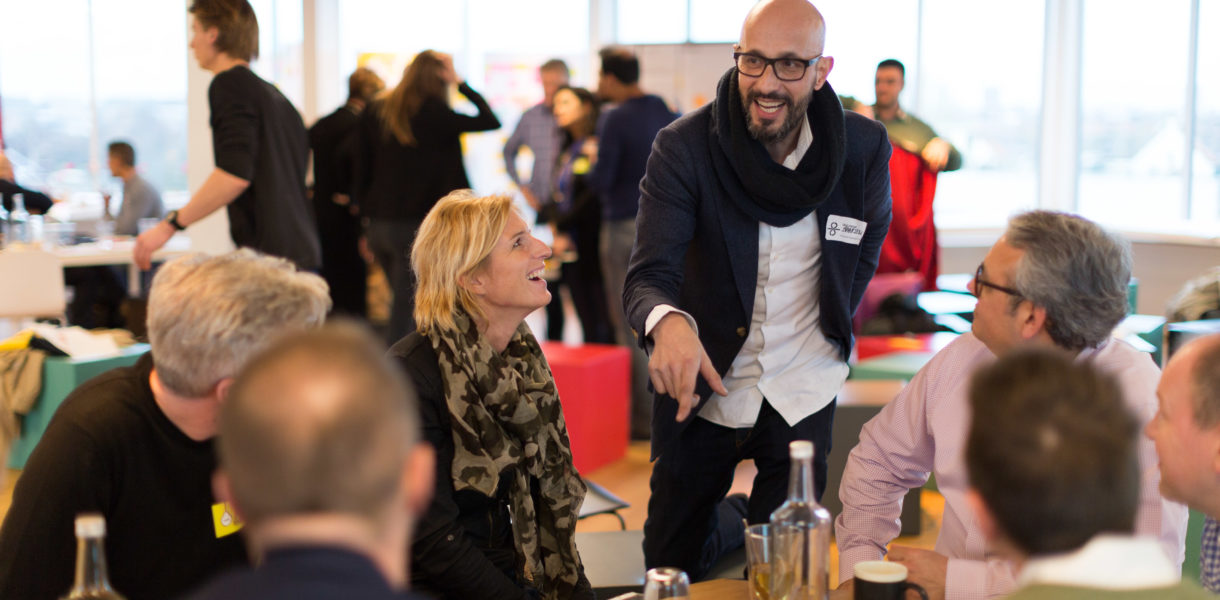 Man in animated conversation about public services at a workshop