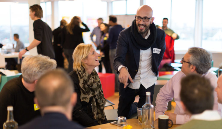 Man in animated conversation about public services at a workshop