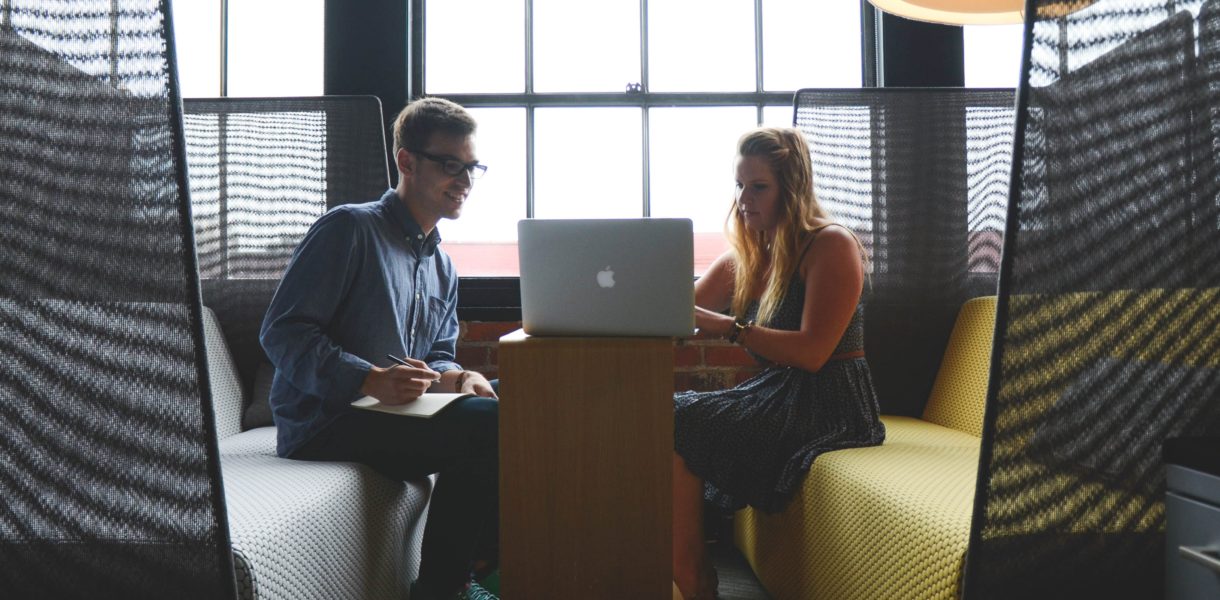 man and woman working on computer