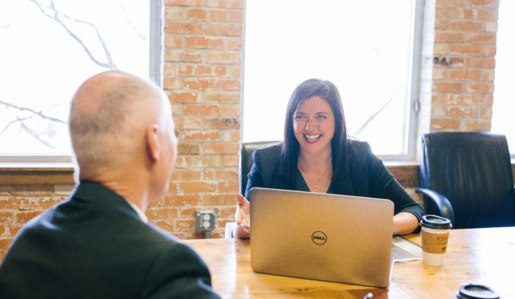 Woman smiling at laptop