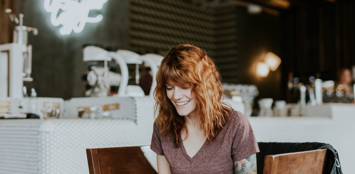 Woman smiling at laptop