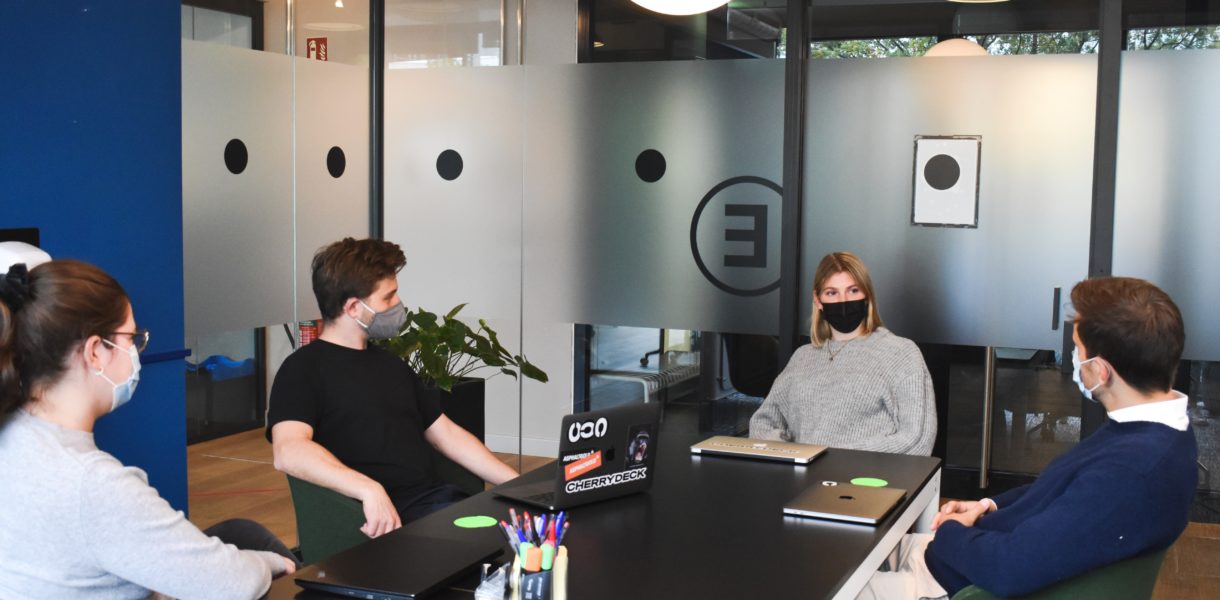 team in the office wearing masks