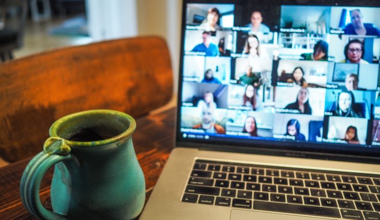online meeting on laptop next to meeting