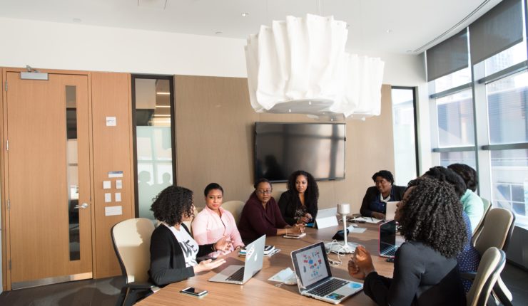A group of women talking in a board room