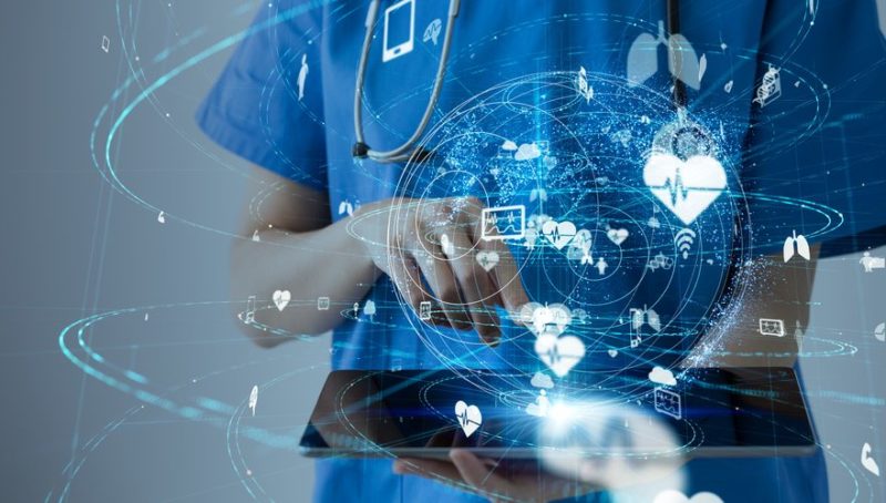 Doctor using tablet device, medical data symbols