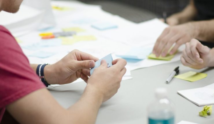 People doing Agile work at a desk around User Research