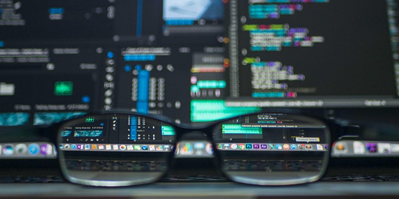 Glasses sat in front of monitors