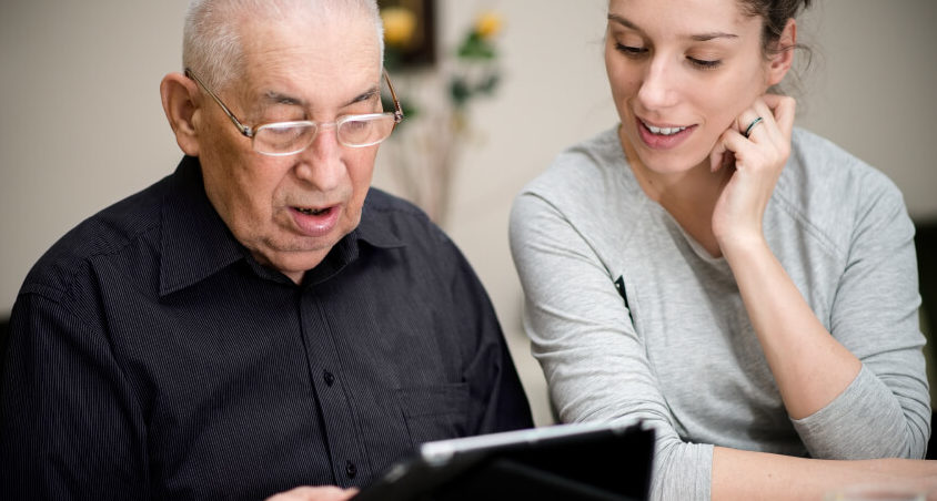 Older person mentored in using technology to combat digital exclusion
