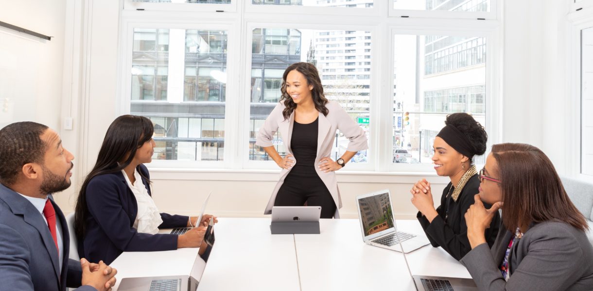 5 people in an office using laptops