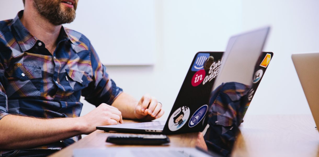 Guy at a desk on a laptop discussing digital change