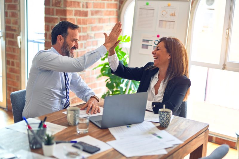 Man and woman hi-5 in the office