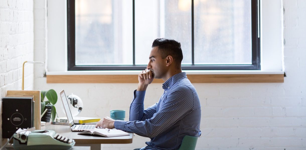 man on laptop at a desk
