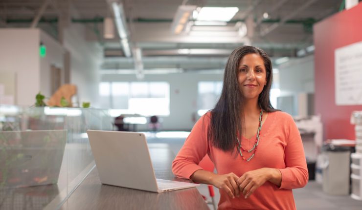 Woman next to a laptop