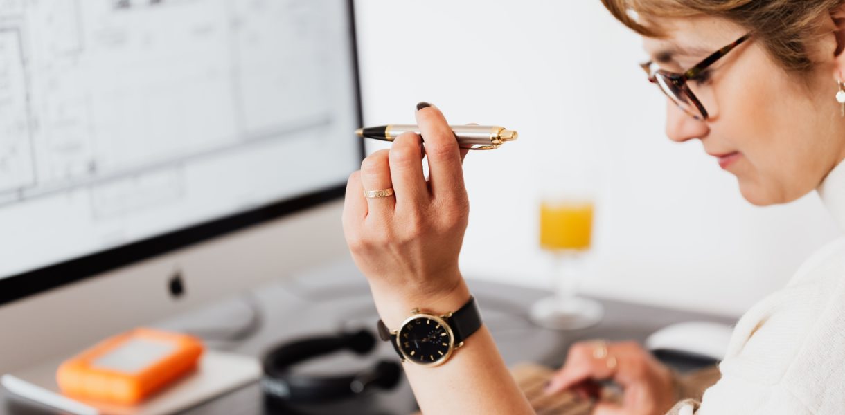 Woman using computer and calculator