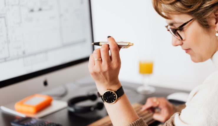 Woman using computer and calculator