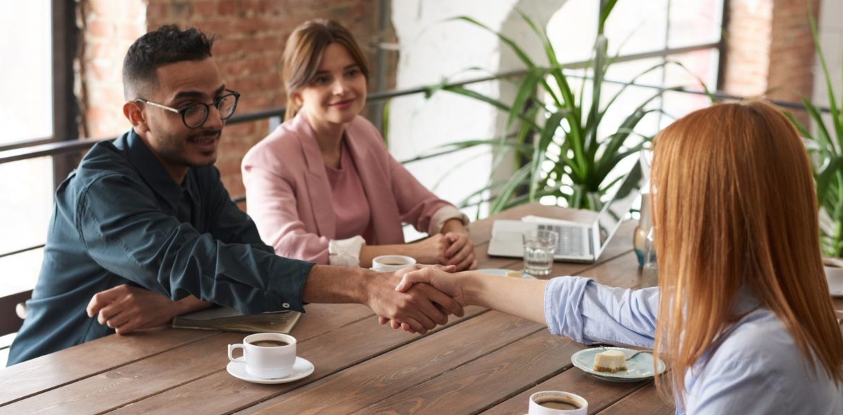 handshake between man and women in office