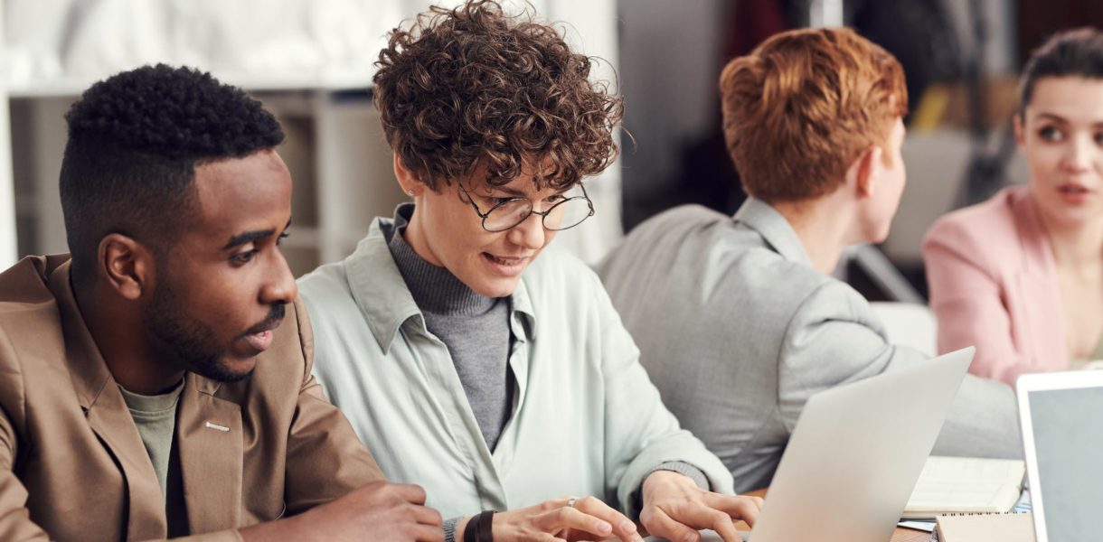 group of people working at desk in office