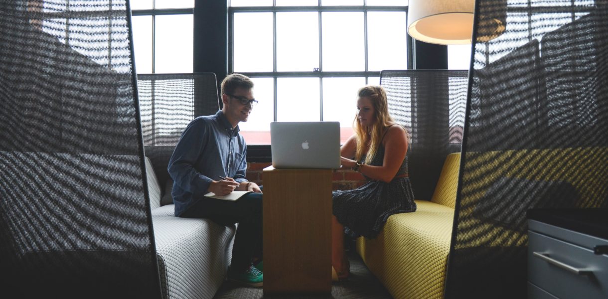 man and woman using laptop