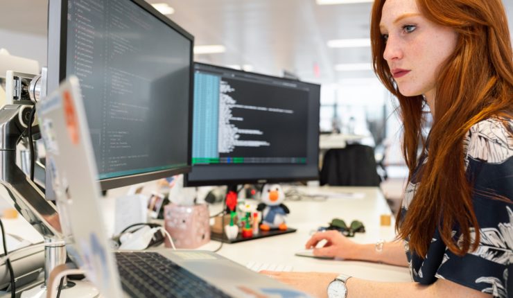 Woman working multy screens