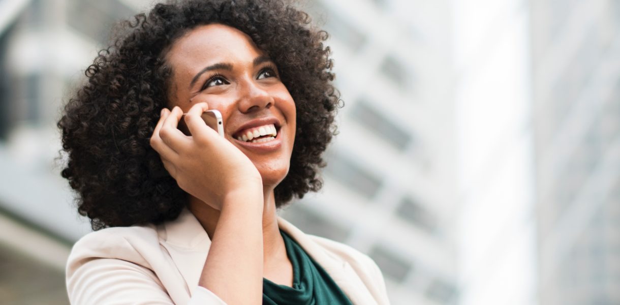 Woman in business attire on her mobile phone