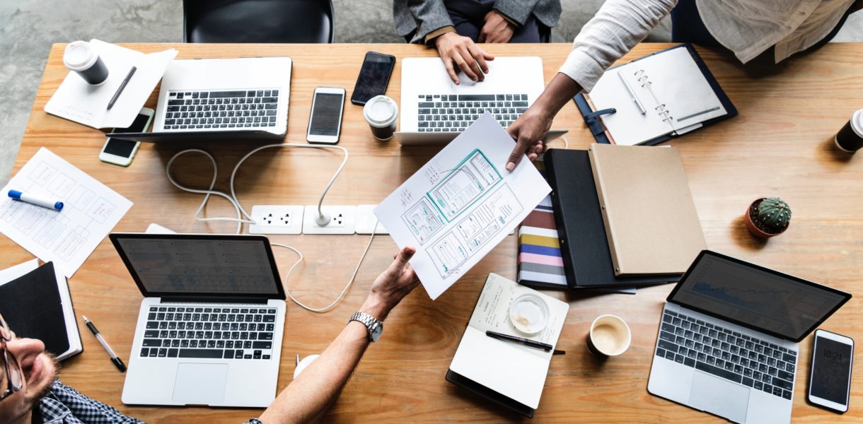 Data driven team around a table with laptops