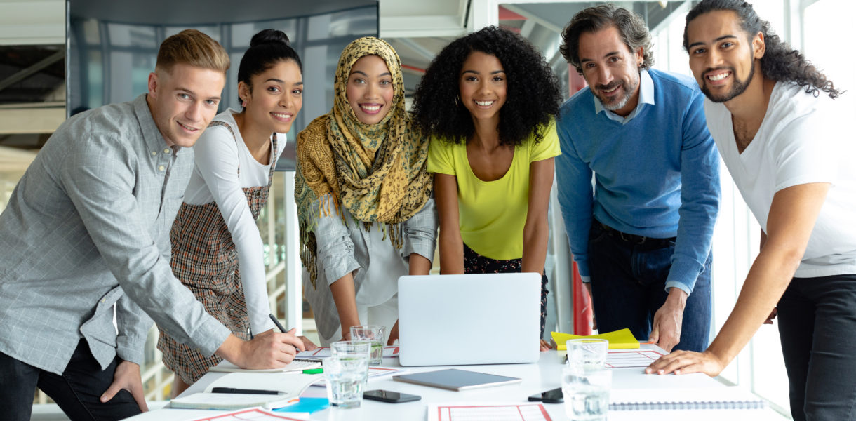 Front,View,Of,Diverse,Business,People,Looking,At,Camera,While