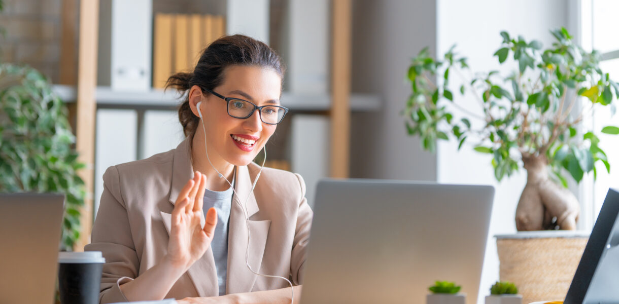 Happy,Casual,Beautiful,Woman,Working,On,A,Laptop,,Talking,With