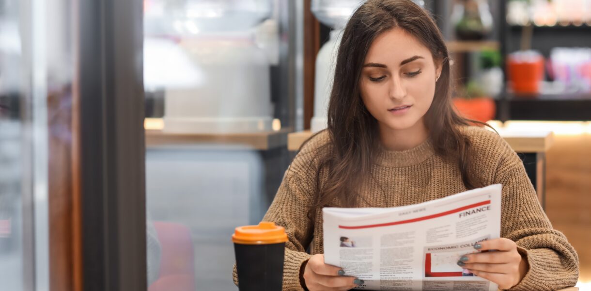 woman reading paper