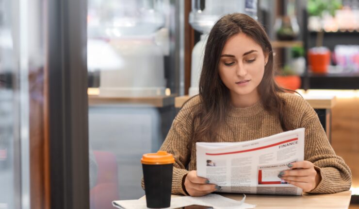 woman reading paper