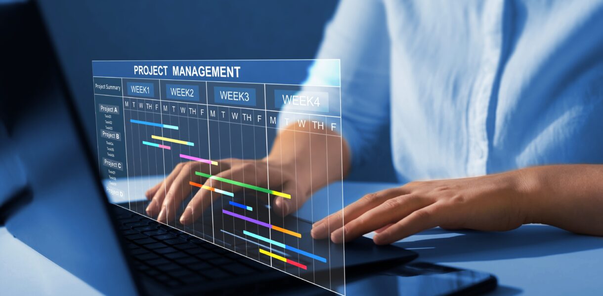 Project,Manager,Working,On,Laptop,And,Updating,Tasks,And,Milestones