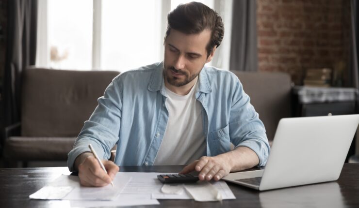 Serious,Handsome,Computer,User,Man,Doing,Accounting,Job,,Checking,Paper
