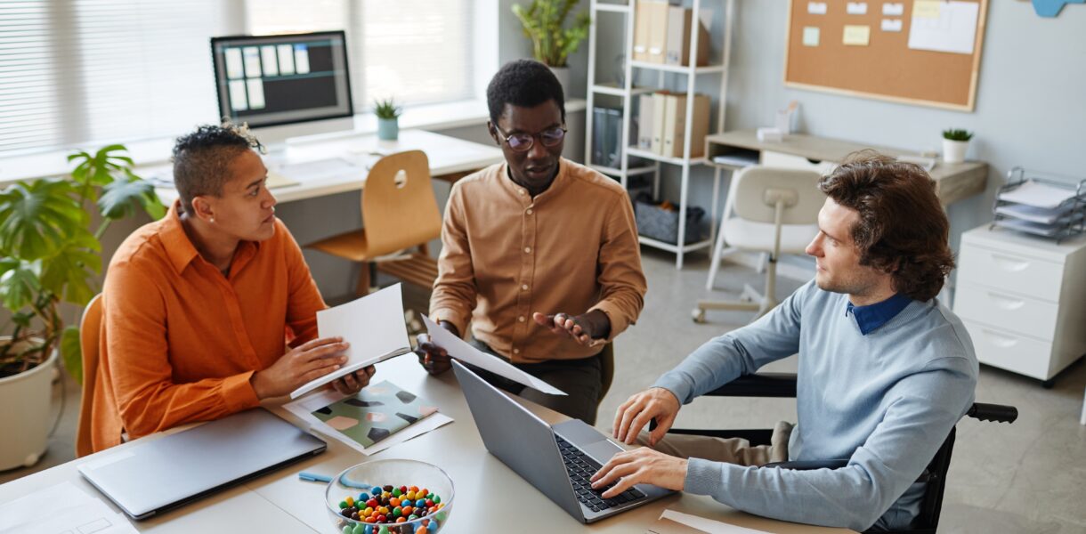 Portrait,Of,Diverse,Business,Team,Discussing,Project,At,Meeting,Table