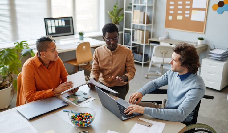 Portrait,Of,Diverse,Business,Team,Discussing,Project,At,Meeting,Table
