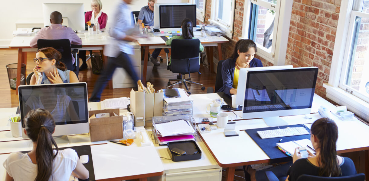 Wide,Angle,View,Of,Busy,Design,Office,With,Workers,At