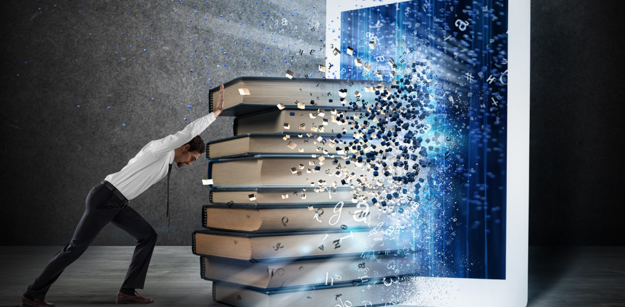 Man pushing books into a tablet device