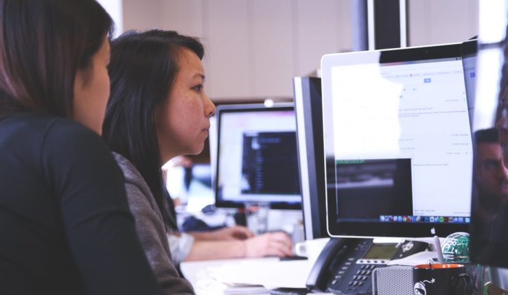 Young people using digital skills and technology on computer