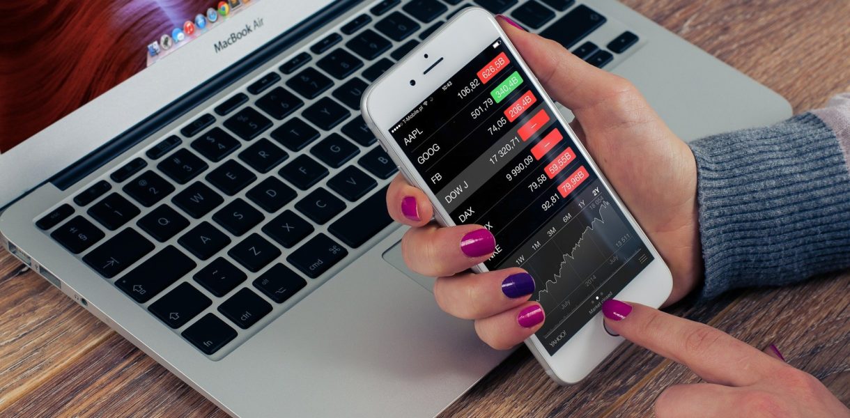 woman checking stocks on devices