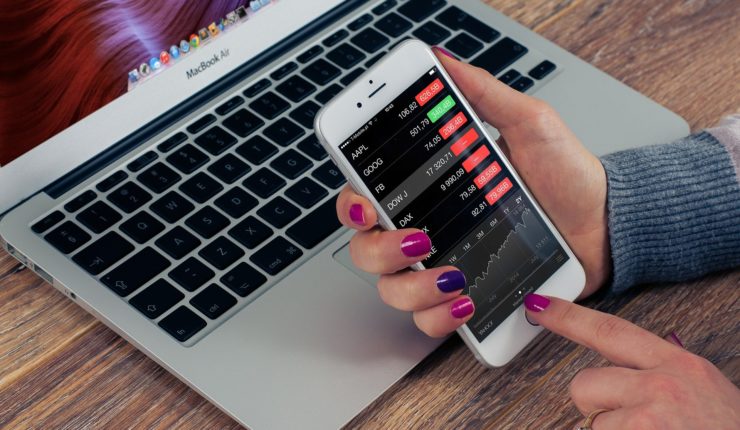 woman checking stocks on devices