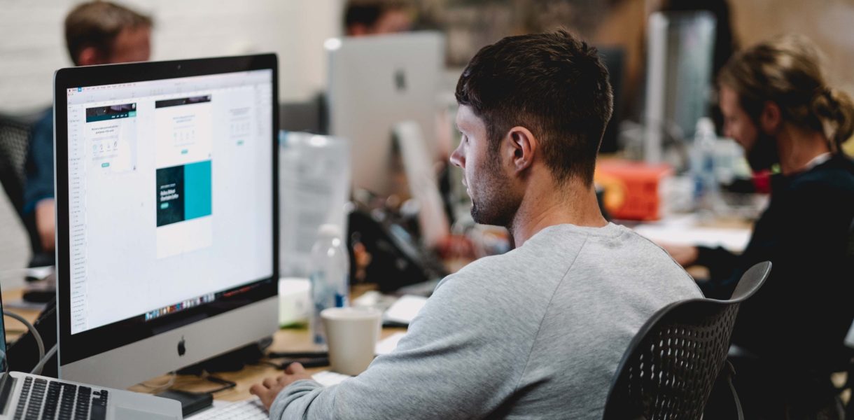 Young man on computer at a desk