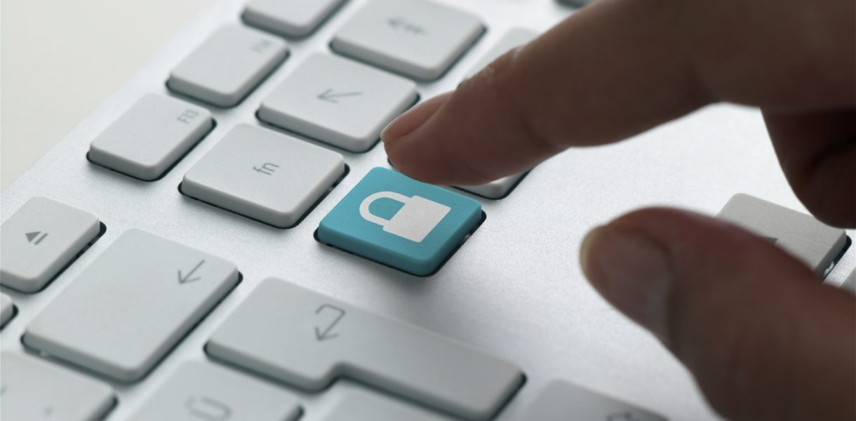 someone about to press a padlock key on a Mac Keyboard, symbolising GDPR
