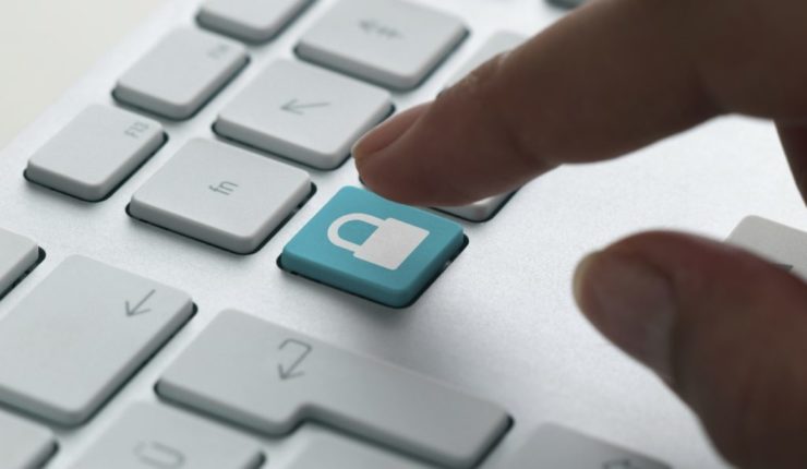 someone about to press a padlock key on a Mac Keyboard, symbolising GDPR