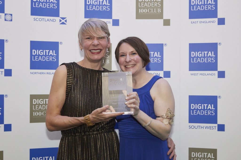 Avril Chester holding Digital leaders 100 Award at event